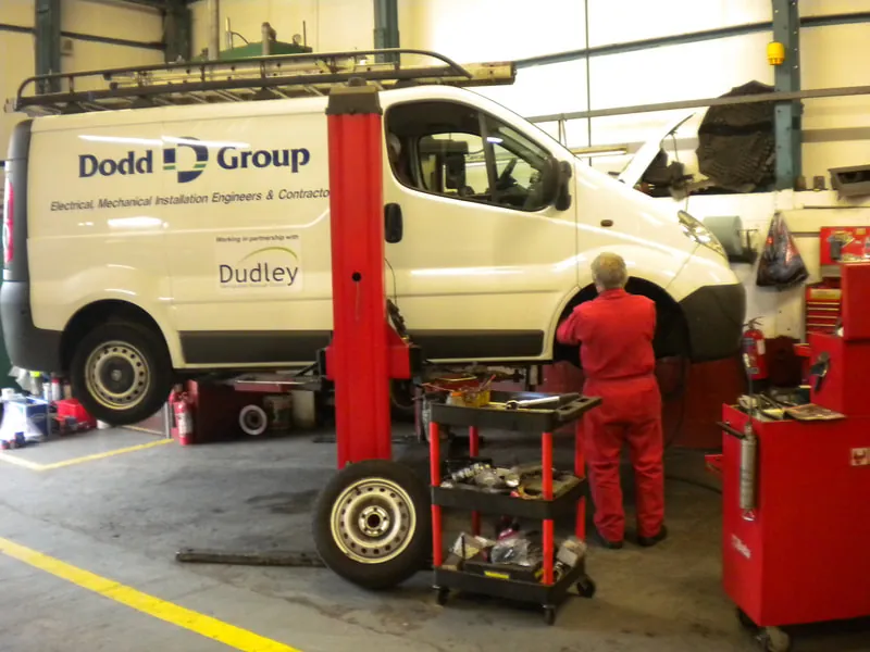 A technician working on a van in the garage