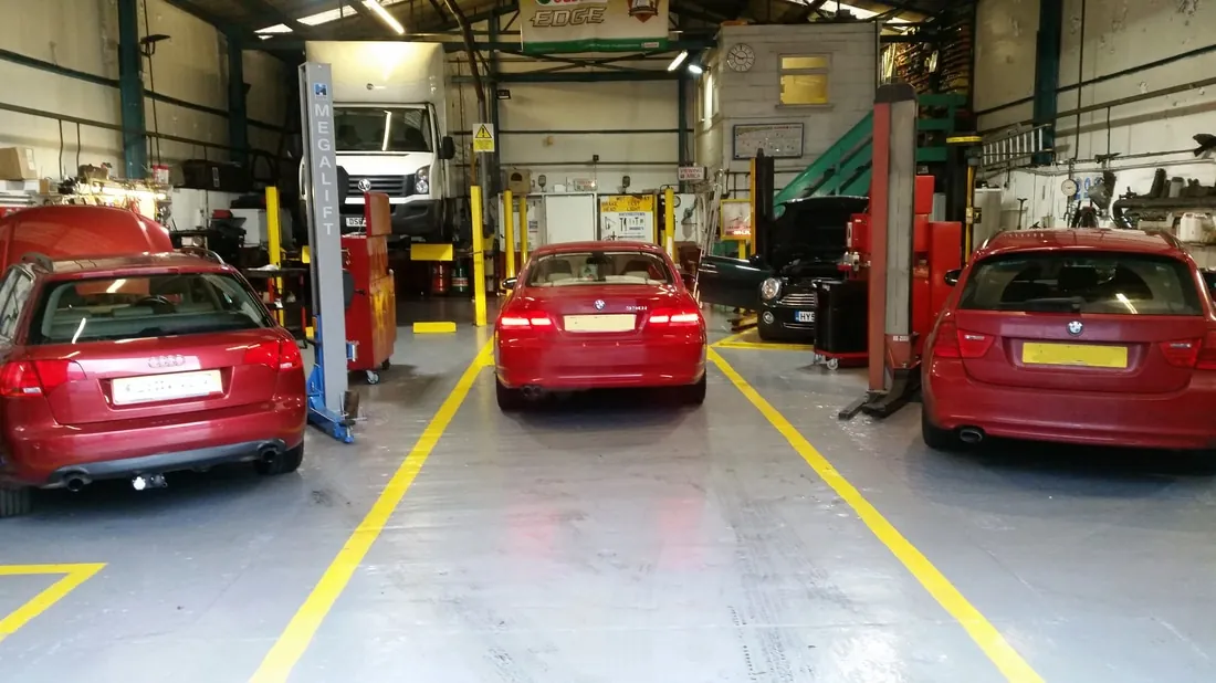 Vehicle maintenance inside the G and J Starkey workshop in Lye